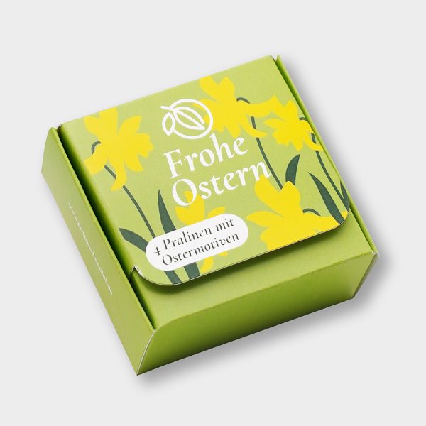 Schachtel für die 4 Osterpralinen. Grün mit Narzissen und der Aufschrift 'Frohe Ostern' in weiß.