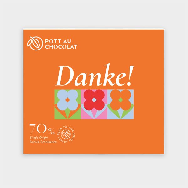 Vorderseite unserer 70% dunklen Schokolade 'Danke' mit kleinen bunten Blumen auf orangenem Hintergrund.