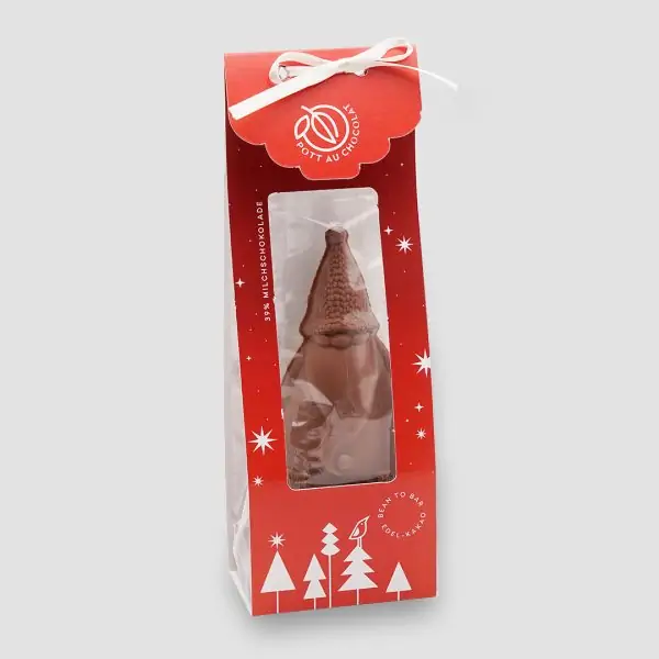 Schoko Weihnachtsmann in Milchschokolade in roter Verpackung mit weißer Schleife und mit Sichtfenster.