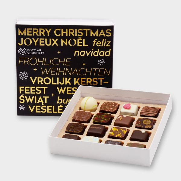 16er Geschenkbox Weihnachten - weiße Pralinenbox mit einer schwarzen Banderole auf der "Fröhliche Weihnachten" in verschiedenen Sprachen mit Gold geprägt ist. Davor steht eine geöffnete Schachtel, die 16 bunt dekorierten Pralinen sind sichtbar.